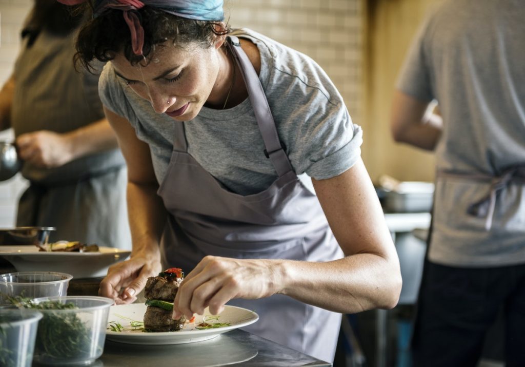 a happy staff is working in the kitchen